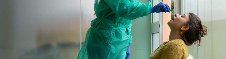 Woman receives a nasal swab.