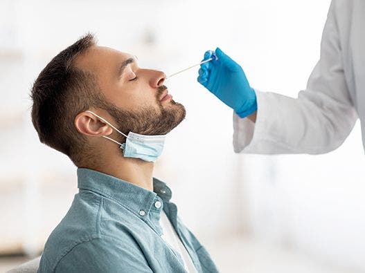 Man receiving a nasal swab.